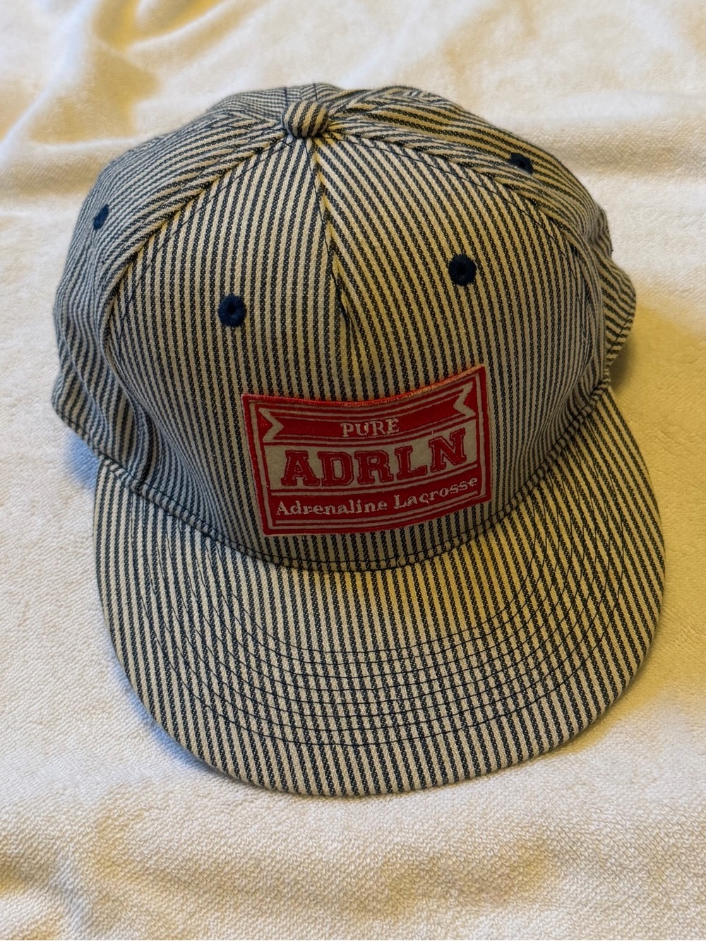 Striped Adrenaline Lacrosse Snapback Hat in Blue and White